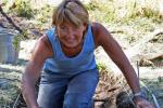 Archaeologist Sandra Peacock excavates an ancient earth oven.