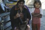 Delsie Selam shows her granddaughter how they used to prepare Lomatium root cakes with mortar and pestle, Toppenish, Washington