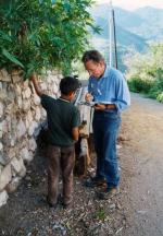 Eugene Hunn interviews a boy identifying plants along a plant trail in San Juan Mixtepec, Oaxaca, Mexico.